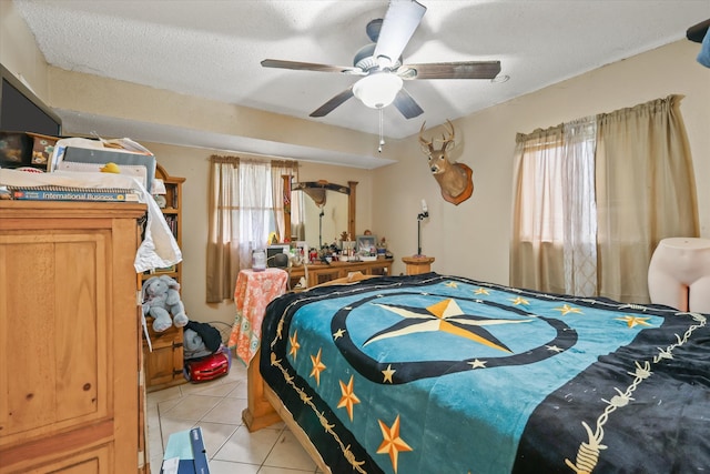 tiled bedroom with a textured ceiling, multiple windows, and ceiling fan