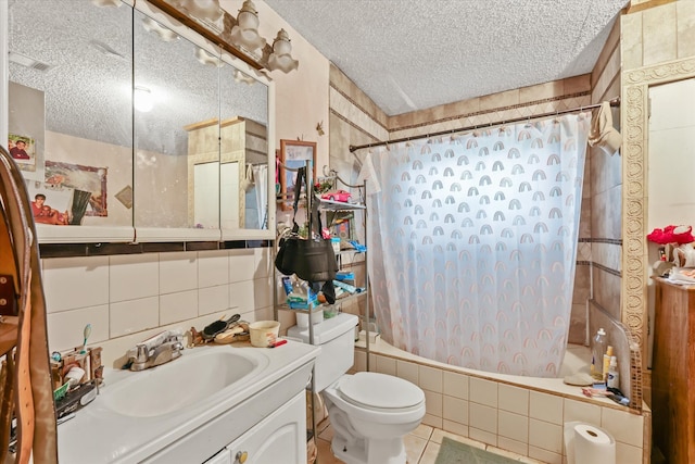 full bathroom with shower / bath combo, toilet, tile walls, tile patterned flooring, and a textured ceiling