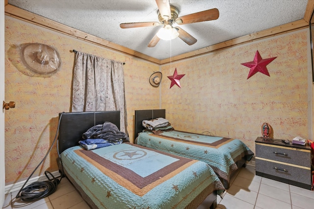 tiled bedroom featuring ornamental molding, a textured ceiling, and ceiling fan