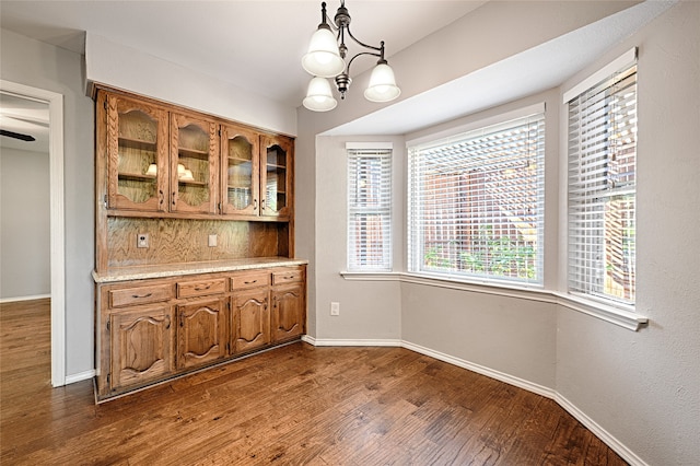 kitchen with a notable chandelier, decorative light fixtures, and dark hardwood / wood-style floors