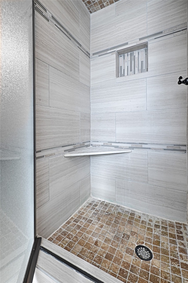 bathroom with tiled shower