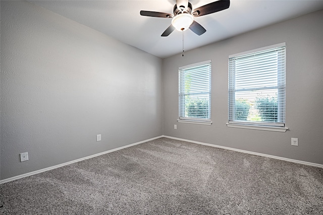 empty room featuring carpet flooring and ceiling fan