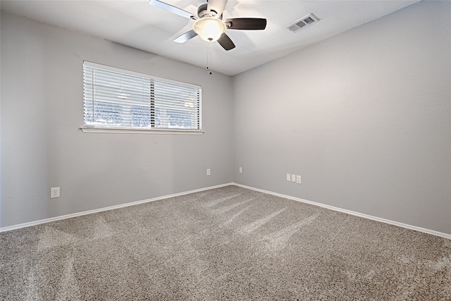 carpeted spare room featuring ceiling fan