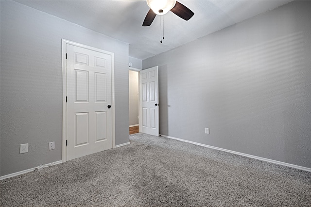 unfurnished bedroom featuring carpet floors and ceiling fan