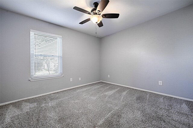 spare room featuring ceiling fan and carpet floors