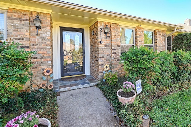 entrance to property with brick siding