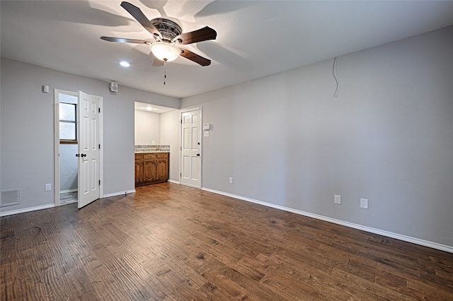 empty room with dark hardwood / wood-style floors and ceiling fan