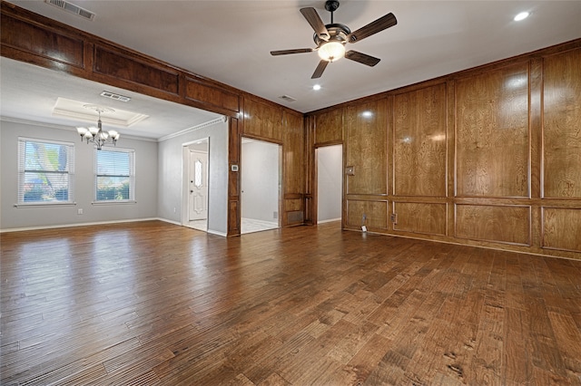 spare room with crown molding, dark hardwood / wood-style flooring, and ceiling fan with notable chandelier