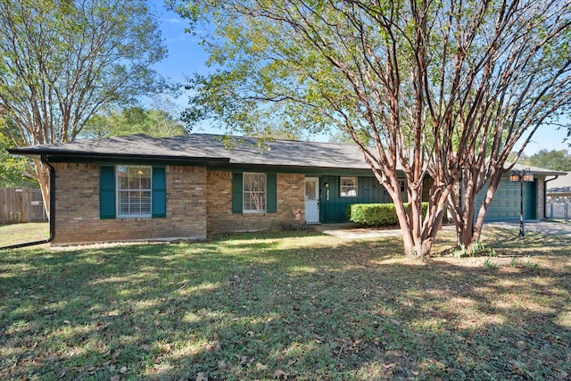 ranch-style home featuring a front yard and a garage