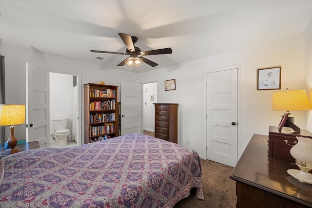 carpeted bedroom featuring ensuite bath and ceiling fan