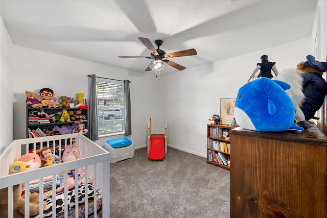 bedroom with ceiling fan, carpet, and a crib