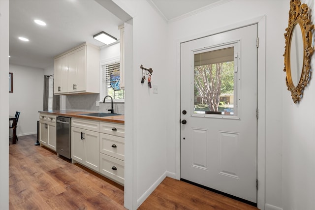 interior space featuring crown molding, light wood-type flooring, and sink