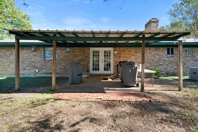 rear view of house featuring central air condition unit and french doors