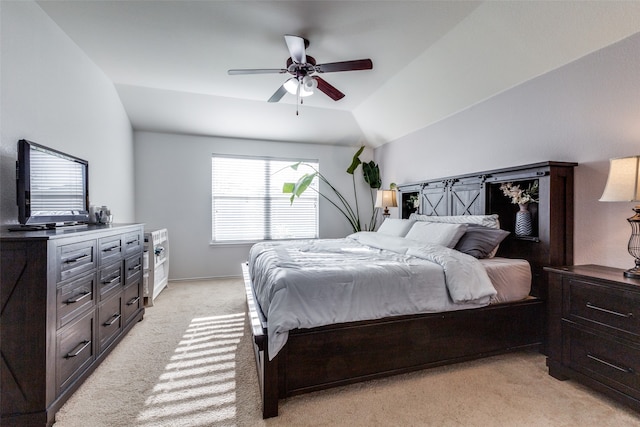 bedroom with light carpet, vaulted ceiling, and ceiling fan