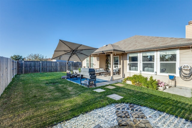 rear view of property featuring a patio area, an outdoor hangout area, and a yard