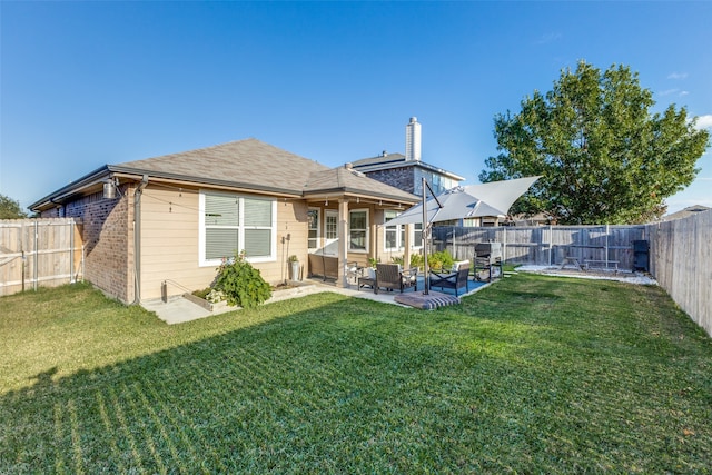 back of property with a lawn, an outdoor hangout area, and a patio