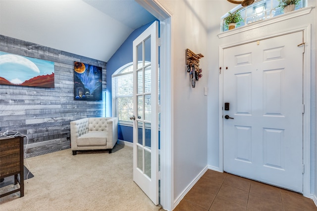 entryway with tile patterned flooring, french doors, and lofted ceiling