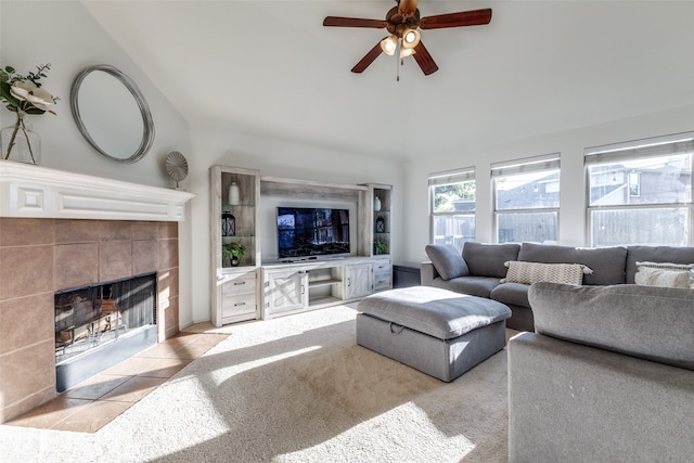 carpeted living room with a fireplace and ceiling fan