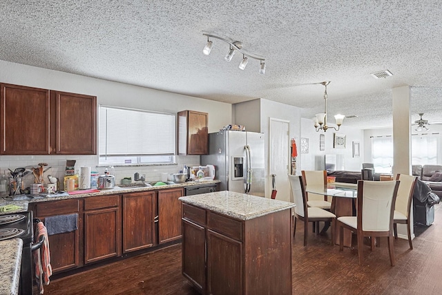 kitchen with sink, stainless steel appliances, a wealth of natural light, and dark wood-type flooring