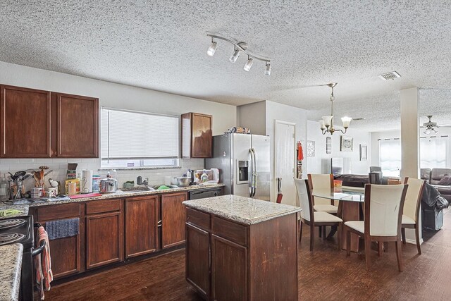 kitchen with sink, stainless steel appliances, a wealth of natural light, and dark wood-type flooring