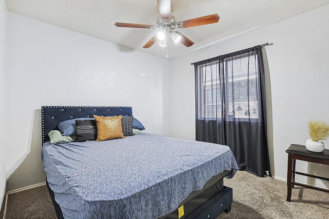 carpeted bedroom featuring a textured ceiling and ceiling fan