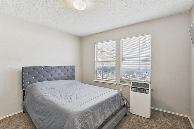 carpeted bedroom featuring a textured ceiling