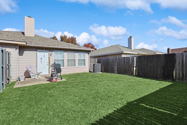 view of yard with central air condition unit and a patio area