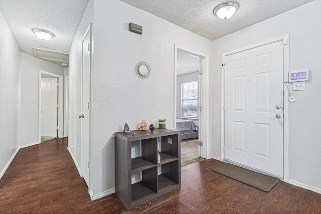 entryway featuring a textured ceiling and dark wood-type flooring