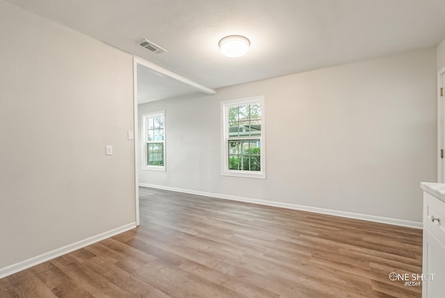 spare room featuring light wood-type flooring