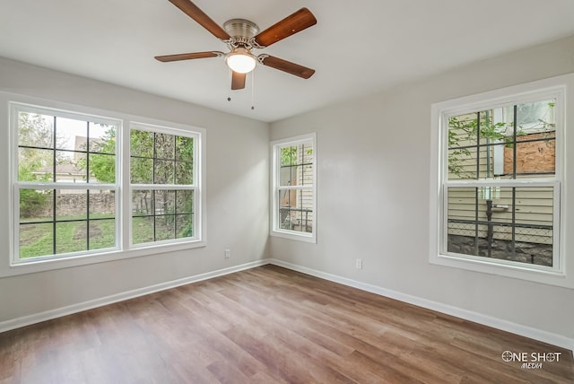 spare room featuring light hardwood / wood-style flooring, plenty of natural light, and ceiling fan