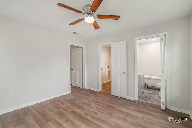 unfurnished bedroom with ensuite bath, ceiling fan, and light wood-type flooring