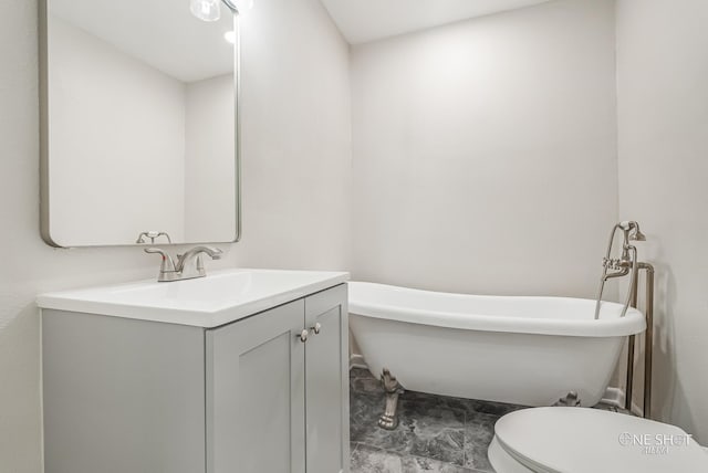 bathroom with a tub to relax in, vanity, and toilet