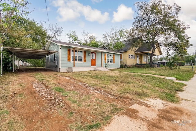 view of front of property with a front lawn and a carport