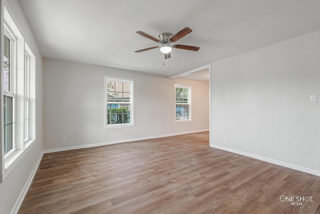 empty room with ceiling fan and light wood-type flooring