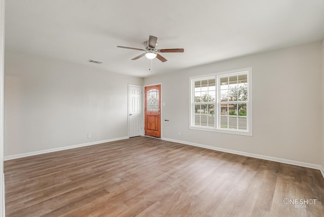 spare room with wood-type flooring and ceiling fan