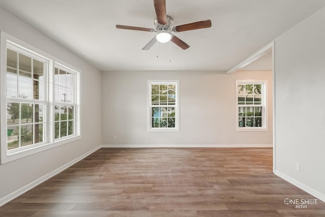 unfurnished room featuring hardwood / wood-style floors and ceiling fan