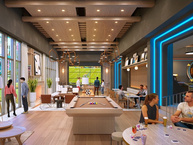 recreation room featuring a towering ceiling, beam ceiling, light wood-type flooring, and pool table