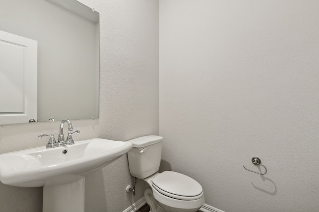 bathroom with toilet and sink