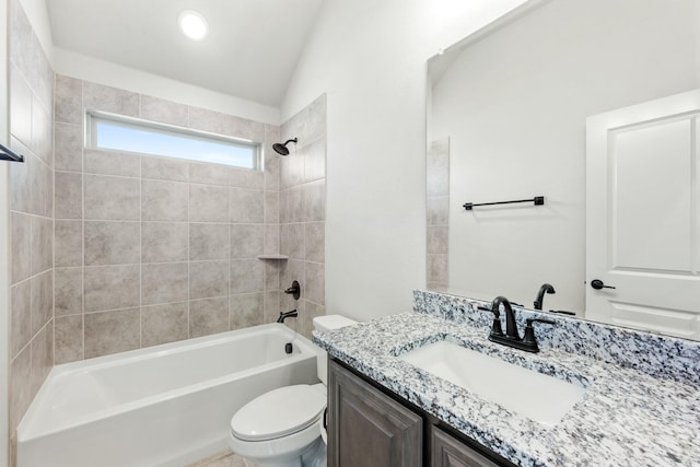 full bathroom featuring vanity, tiled shower / bath combo, vaulted ceiling, and toilet