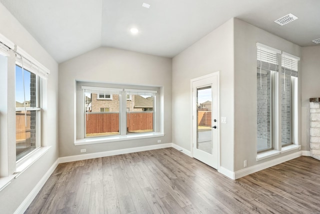 interior space featuring hardwood / wood-style floors and lofted ceiling