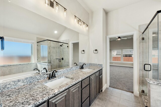 bathroom featuring ceiling fan, tile patterned floors, vaulted ceiling, vanity, and a shower with shower door