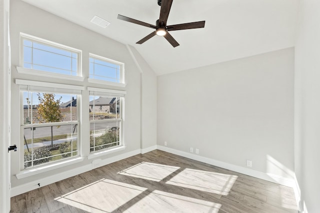 empty room with ceiling fan, wood-type flooring, and lofted ceiling