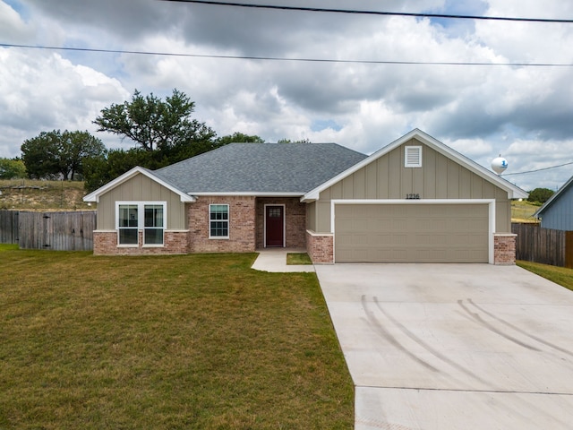 view of front of house with a garage and a front lawn