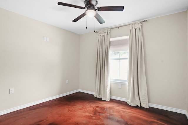 spare room featuring dark wood-type flooring and ceiling fan