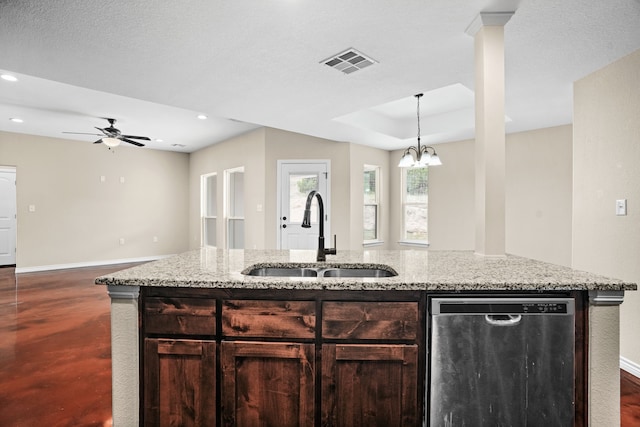 kitchen featuring a center island with sink, sink, light stone countertops, a textured ceiling, and stainless steel dishwasher