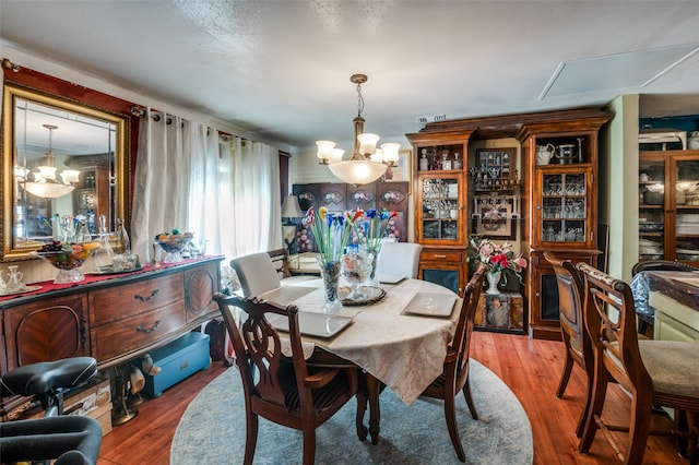 dining space featuring an inviting chandelier and hardwood / wood-style floors