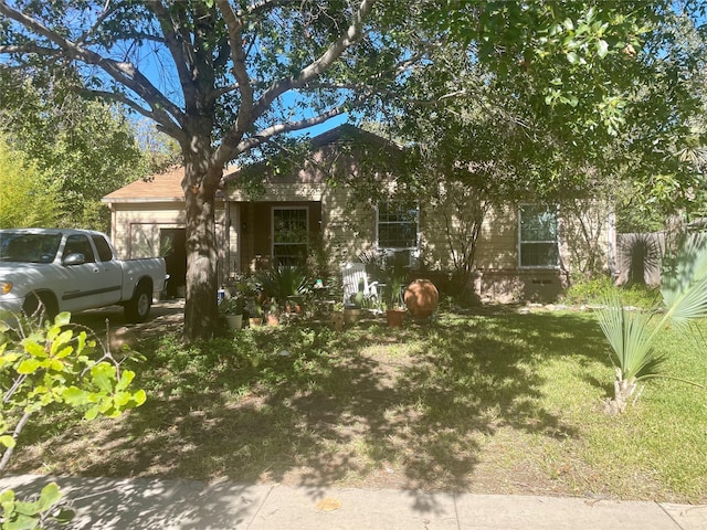 obstructed view of property featuring a front lawn