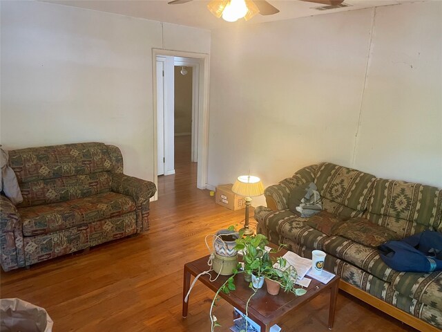 living room with hardwood / wood-style floors and ceiling fan