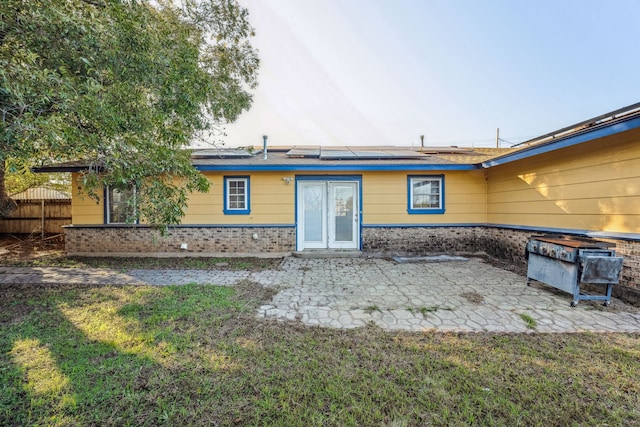 back of property featuring a yard and a patio area