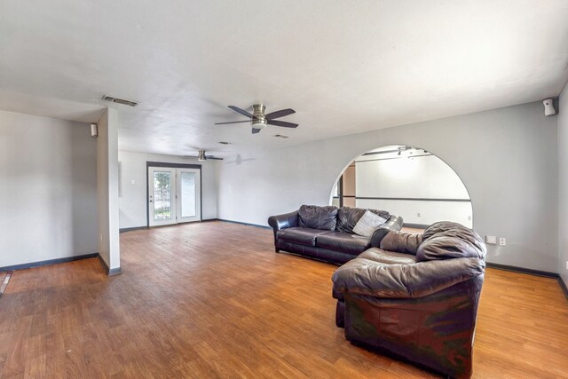 living room with wood-type flooring and ceiling fan